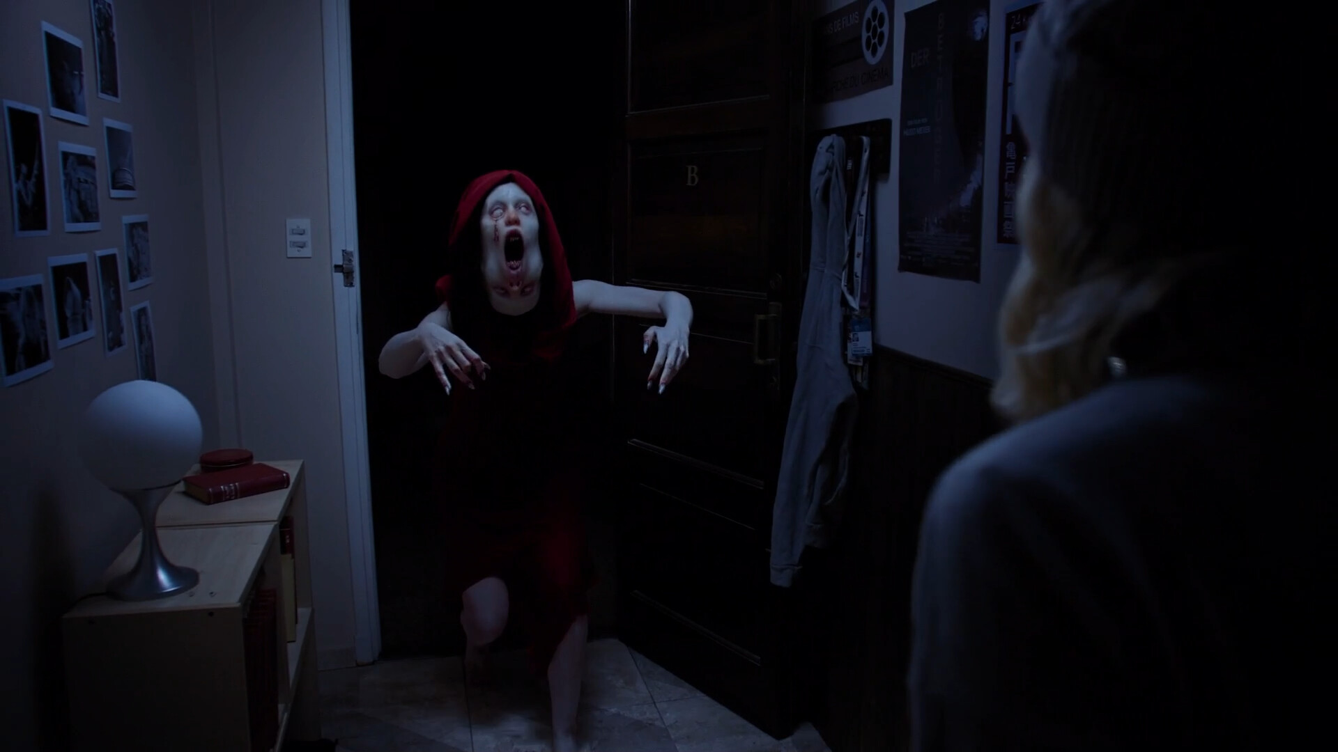 Tenebris Somnia live-action horror scene of a red-cloaked ghost attacking the protagonist.